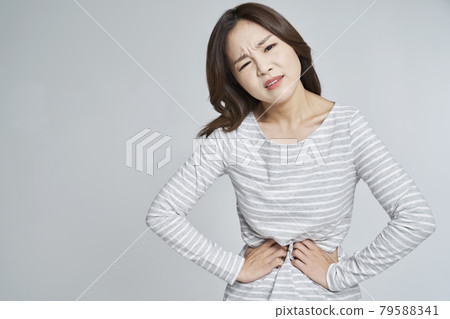 abdominal pain, menstruation, menstrual cramps, pain, young woman, nukki, gray background 79588341