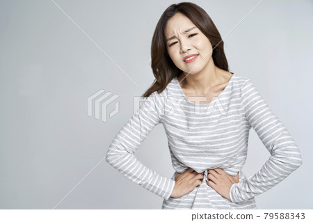 abdominal pain, menstruation, menstrual cramps, pain, young woman, nukki, gray background abdominal pain, menstruation, menstrual cramps, pain, young woman, nukki, gray background 79588343