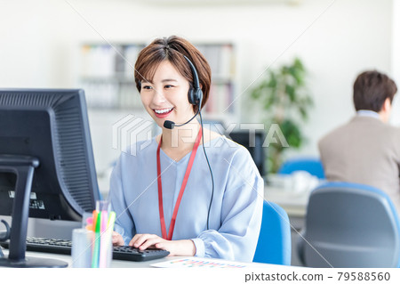 A business woman who wears a headset and responds 79588560