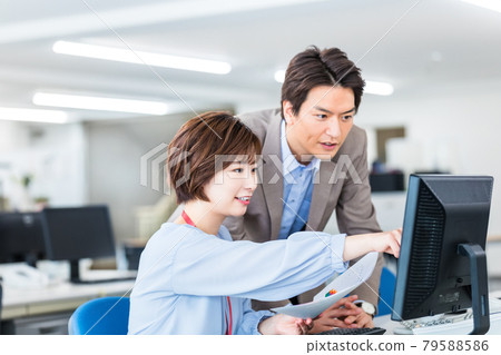 A business person who inputs to a computer while consulting with his boss A business person who inputs to a computer while consulting with his boss 79588586