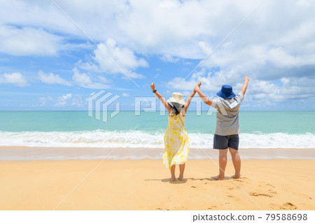 Happy children are back with their hands raised together on a beach at phuket, Happy children are back with their hands raised together on a beach at phuket, 79588698
