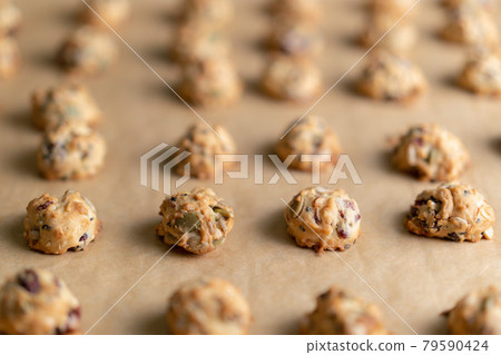 grains cookies on waxed sheet. 79590424