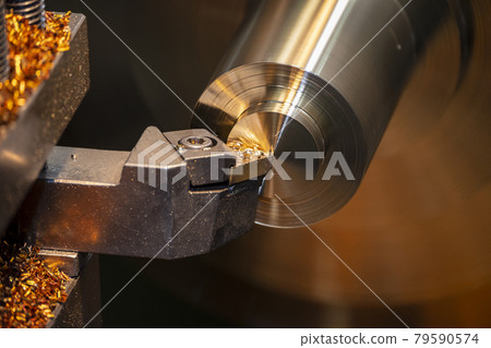 The close-up scene of lathe machine finish cut process the brass shaft material.  79590574
