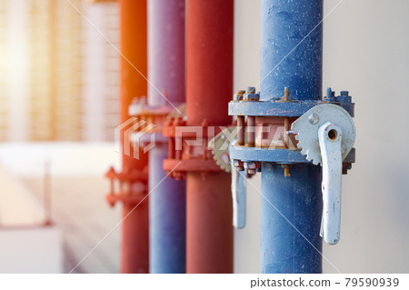 water pipes of industry building watering system at roof top outdoor closeup pipe valve with handle lock. 79590939