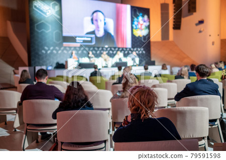 Businessman listening to online speaker 79591598