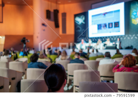 Business conference participants sitting in auditorium 79591599