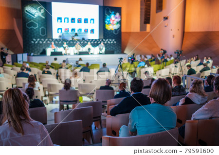Business conference participants sitting in auditorium Business conference participants sitting in auditorium 79591600