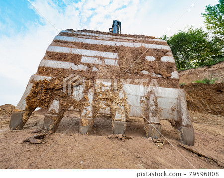Industrial toothed digger bucket bite the ground. Industrial toothed digger bucket bite the ground. 79596008