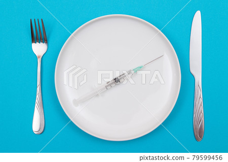 Medical Disposable Syringe on White Ceramic Plate Medical Disposable Syringe on White Ceramic Plate 79599456