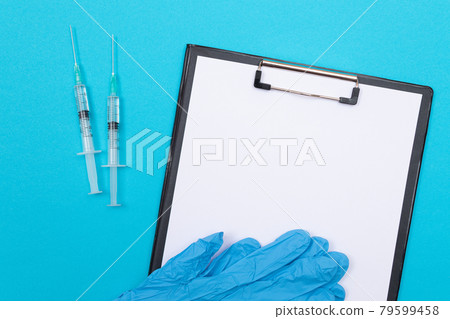 Vaccination or Revaccination Concept - Two Medical Syringe on Blue Table Vaccination or Revaccination Concept - Two Medical Syringe on Blue Table 79599458