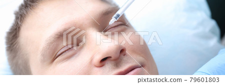 Man is given rejuvenating injection in his face 79601803