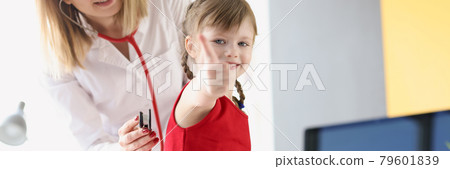 Smiling pediatrician doctor listens through stethoscope to breathing of the lungs of little girl Smiling pediatrician doctor listens through stethoscope to breathing of the lungs of little girl 79601839