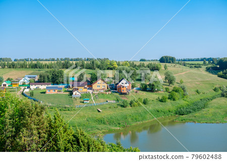village near lake. Landscape of the village with beautiful views of the forest and lake 79602488