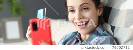 Happy woman holding mobile phone and credit bank card 79602711