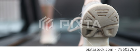 Woman athlete walking on treadmill in gym closeup 79602769