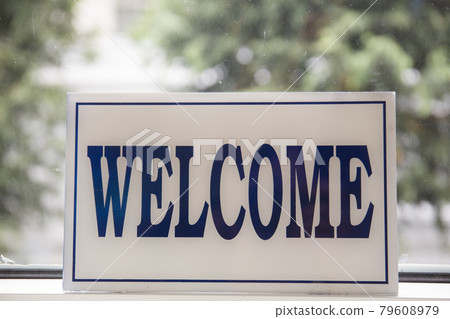 Close up shot of welcome sign on window	 79608979