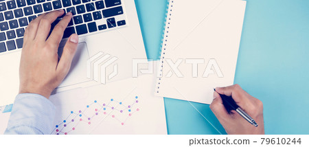 Hand of businessman looking documents report statistic financial with graph and chart and laptop. Hand of businessman looking documents report statistic financial with graph and chart and laptop. 79610244