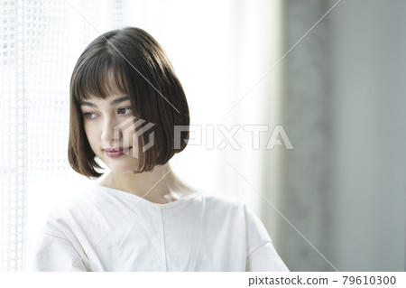 Portrait of a woman by the window 79610300