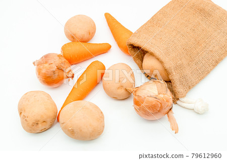 Carrots, potatoes, onions spilling from jute bags Carrots, potatoes, onions spilling from jute bags 79612960