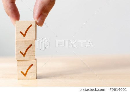 Checklist concept, Check mark on wooden blocks on table with copy space 79614001