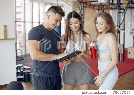 Young sports people training in a morning gym Young sports people training in a morning gym 79617055