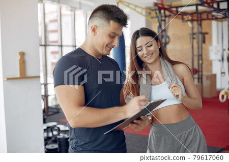 Young sports people training in a morning gym Young sports people training in a morning gym 79617060