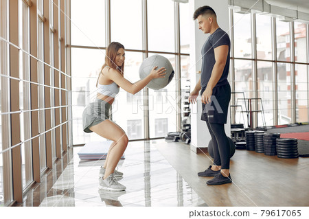 Young sports people training in a morning gym Young sports people training in a morning gym 79617065