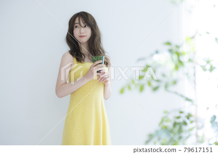 A woman by the window A woman by the window 79617151