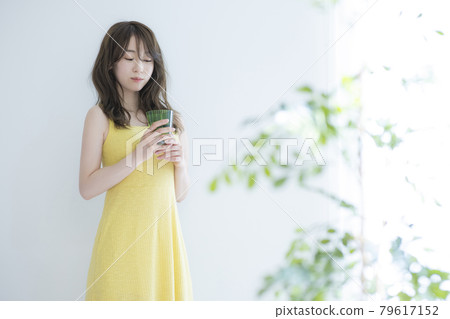 A woman by the window A woman by the window 79617152