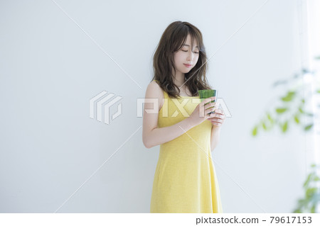 A woman by the window A woman by the window 79617153