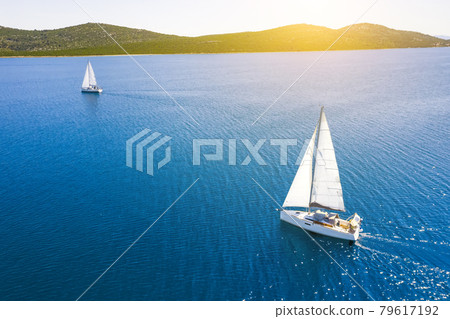 Yacht sailing at sunset during a storm. Luxury vacation at sea 79617192