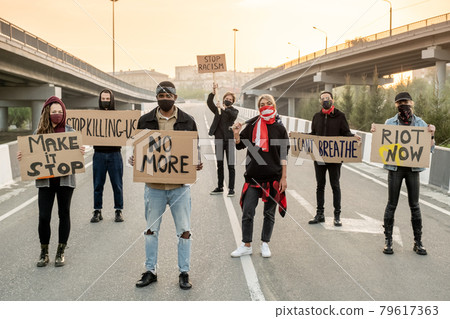 Group of protestors on road 79617363