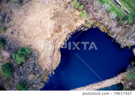 Aerial view, vertical down, of a blue lake in the heath 79617487