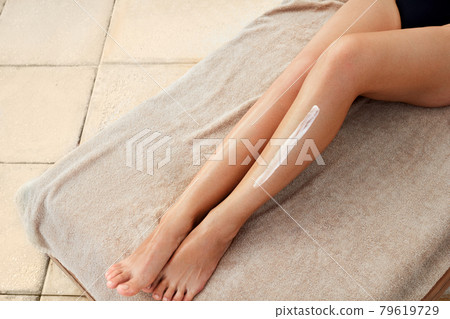 Woman hand is applying moisturizing lotion on skin. Beauty and Body care. Protection from cellulite.   79619729