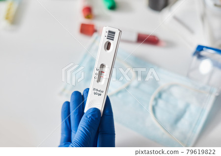 Doctor holding a test kit for viral disease coronavirus. Lab card kit test for COVID-19 2019-nCoV. Rapid test device virus Doctor holding a test kit for viral disease coronavirus. Lab card kit test for COVID-19 2019-nCoV. Rapid test device virus 79619822