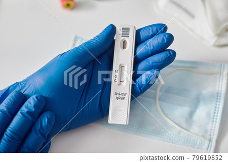 Doctor holding a test kit for viral disease COVID-19 2019-nCoV. Lab card kit test for viral sars-cov-2 virus. Rapid test device coronavirus Doctor holding a test kit for viral disease COVID-19 2019-nCoV. Lab card kit test for viral sars-cov-2 virus. Rapid test device coronavirus 79619852