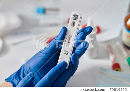 Doctor holding a test kit for viral disease coronavirus. Lab card kit test for COVID-19 2019-nCoV. Rapid test device virus Doctor holding a test kit for viral disease coronavirus. Lab card kit test for COVID-19 2019-nCoV. Rapid test device virus 79619853