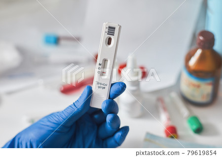 Doctor holding a test kit for viral disease coronavirus. Lab card kit test for COVID-19 2019-nCoV. Rapid test device virus 79619854