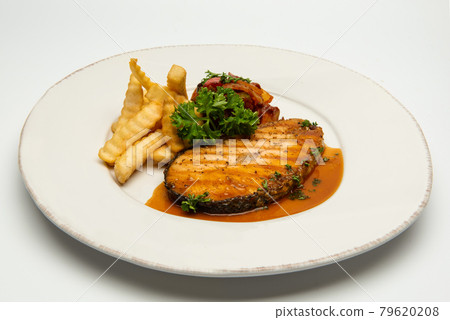 Grilled salmon with lemon and potato on background. Grilled salmon with lemon and potato on background. 79620208