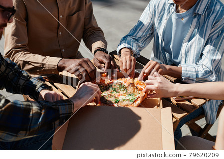 Friends Eating Pizza Outdoors Closeup 79620209