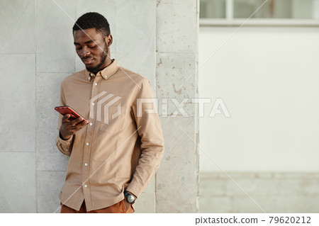 Young African American Man Using Smartphone Young African American Man Using Smartphone 79620212