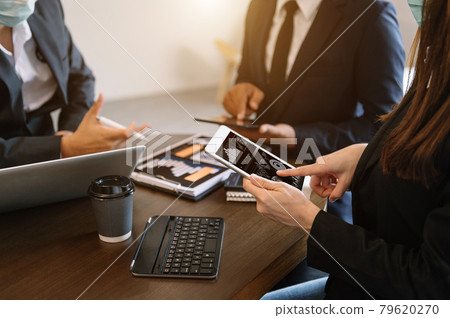 Business documents on office table with smart phone and calculator digital tablet and graph business with social network diagram and two colleagues discussing data working in office Business documents on office table with smart phone and calculator digital tablet and graph business with social network diagram and two colleagues discussing data working in office 79620270