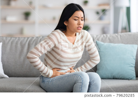 Stomach Ache. Sick Asian Woman Suffering From Acute Abdominal Pain At Home Stomach Ache. Sick Asian Woman Suffering From Acute Abdominal Pain At Home 79620285