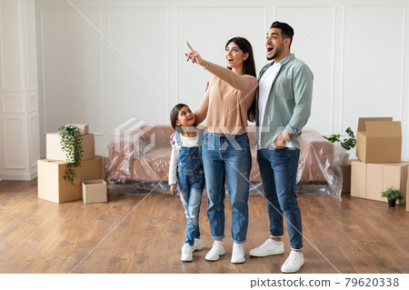 Happy muslim family buying new apartment, pointing up 79620338