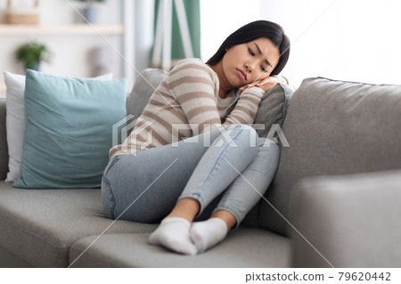 Depression Concept. Portrait Of Sad Asian Woman Sitting On Sofa At Home 79620442