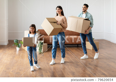 Happy young family holding boxes in new flat Happy young family holding boxes in new flat 79620654
