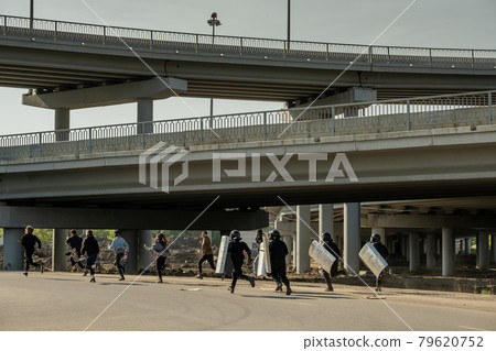 Riot police running for law-breakers 79620752