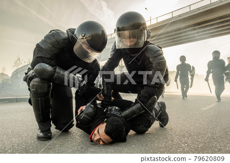 Arresting protester on street Arresting protester on street 79620809