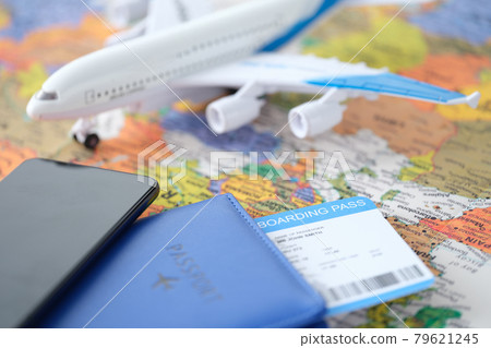 Smartphone and passport with tickets lie on world map with small plane Smartphone and passport with tickets lie on world map with small plane 79621245