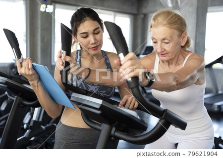 Healthcare: Physio therapy sports trainer with her client in fitness. Healthcare: Physio therapy sports trainer with her client in fitness. 79621904